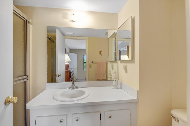bathroom featuring a stall shower and vanity