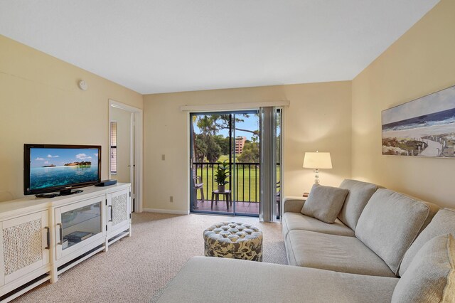 living room with light carpet and baseboards
