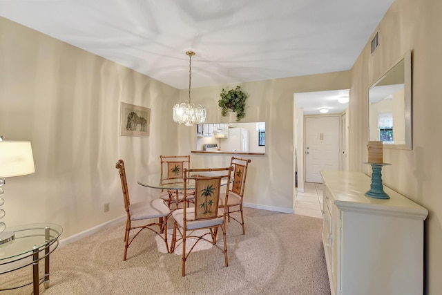 carpeted dining space with a notable chandelier