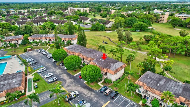 view of property location featuring a golf course, nearby suburban area, and a pool area