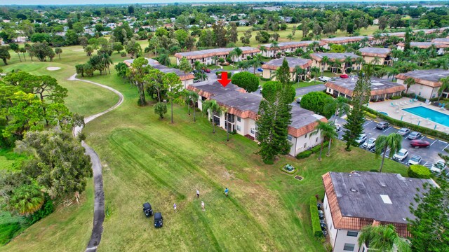 aerial overview of property's location featuring a pool and a golf club