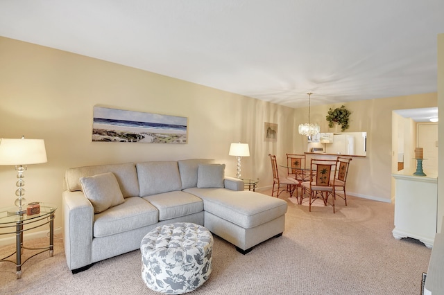 carpeted living room featuring a chandelier