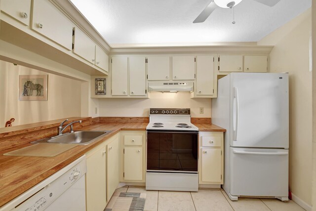 kitchen with white appliances, under cabinet range hood, a sink, a chandelier, and butcher block countertops