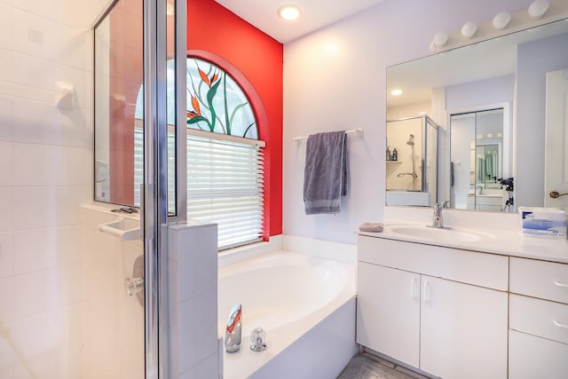 bathroom featuring independent shower and bath and large vanity