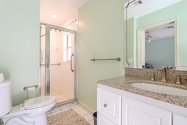 bathroom with a shower with door, tile flooring, vanity with extensive cabinet space, and toilet