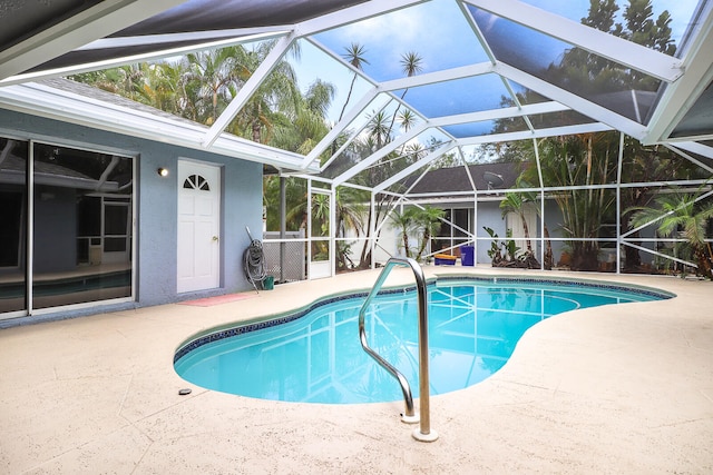 view of pool featuring a patio and glass enclosure