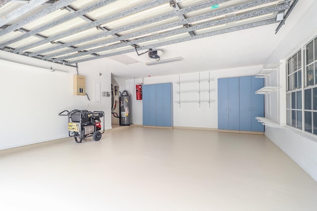 garage with a garage door opener and electric water heater