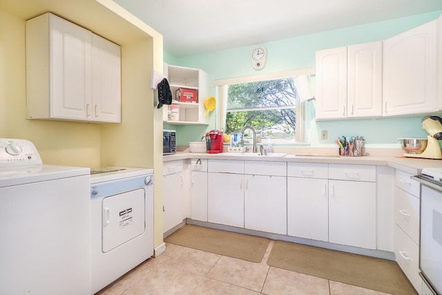 washroom featuring sink, washer / dryer, and light tile floors