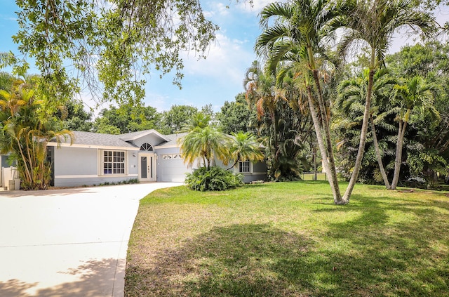 ranch-style home with a garage and a front yard