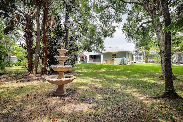 view of yard featuring a lanai