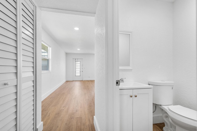 bathroom featuring hardwood / wood-style floors, vanity, and toilet