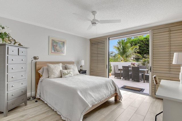 bedroom featuring light hardwood / wood-style flooring, ceiling fan, a textured ceiling, and access to outside