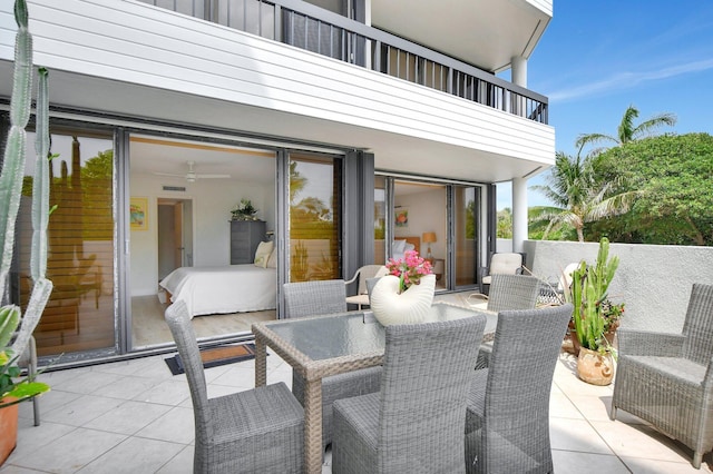 view of patio / terrace with ceiling fan and a balcony