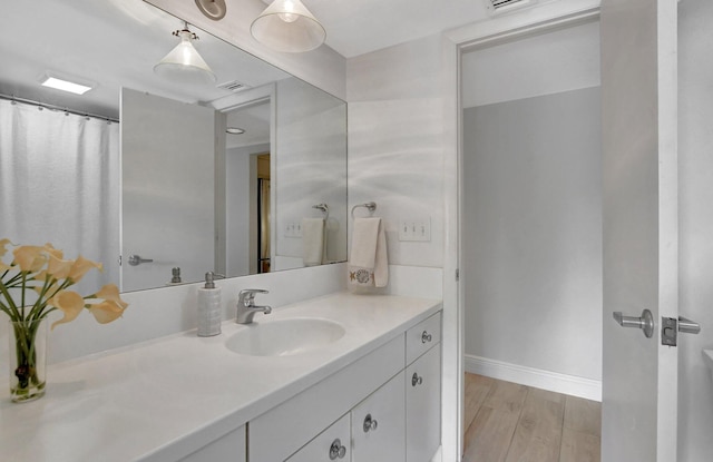 bathroom featuring hardwood / wood-style flooring and vanity