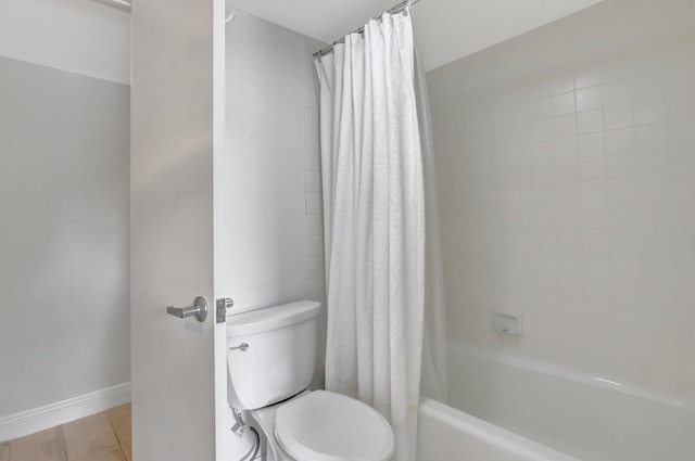 bathroom featuring toilet, hardwood / wood-style flooring, and shower / bath combo