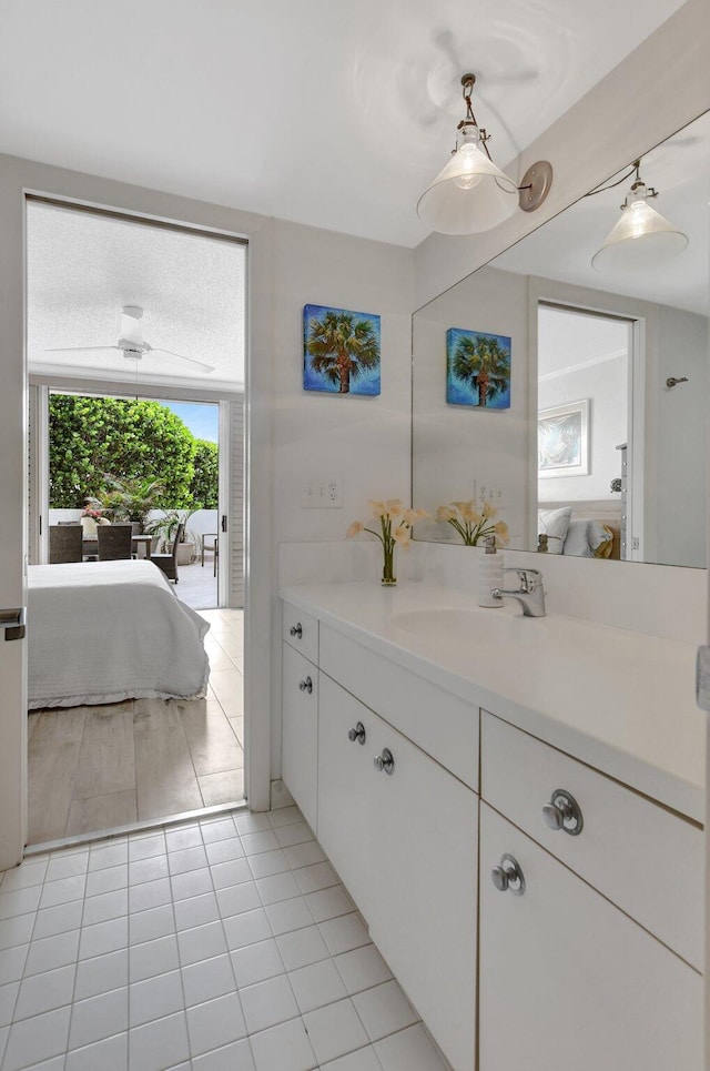 bathroom with tile flooring, ceiling fan, and vanity