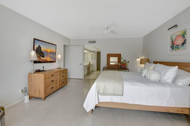 bedroom with ensuite bath and ceiling fan