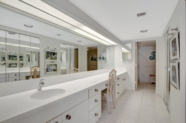 bathroom featuring tile floors and oversized vanity