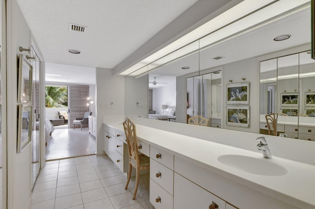 bathroom with tile flooring and vanity