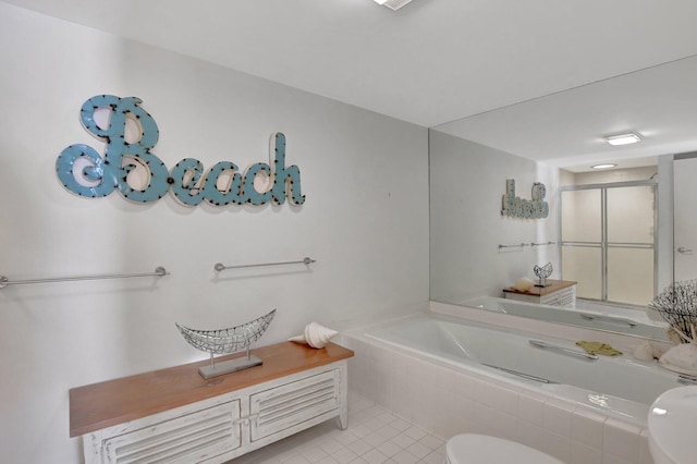 bathroom with tile floors, tiled tub, toilet, and vanity