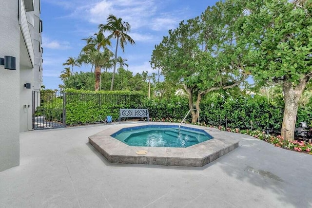 view of pool featuring a patio area and an in ground hot tub