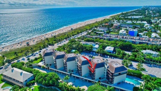 birds eye view of property with a beach view and a water view