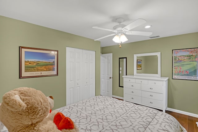 bedroom with ceiling fan, hardwood / wood-style flooring, and a closet