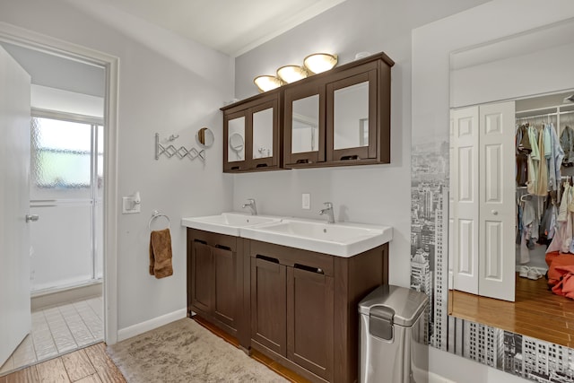 bathroom with a shower, vanity, and hardwood / wood-style flooring