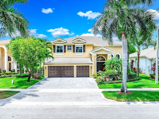 view of front of home with a front yard and a garage