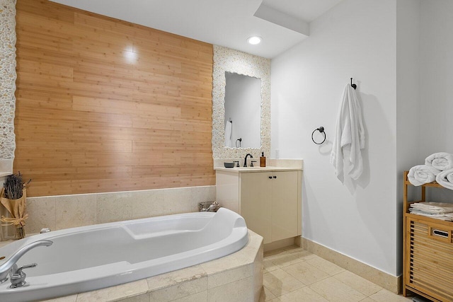 bathroom with tile floors, a relaxing tiled bath, wooden walls, and oversized vanity