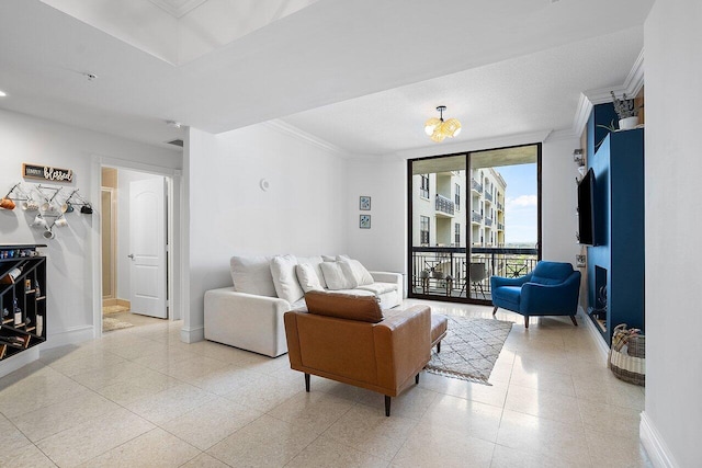 tiled living room featuring ornamental molding, a wall of windows, and an inviting chandelier