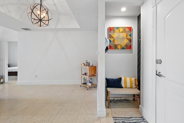 living area with light tile flooring and a raised ceiling