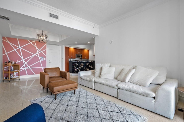 living room featuring tile flooring, a textured ceiling, a raised ceiling, and crown molding