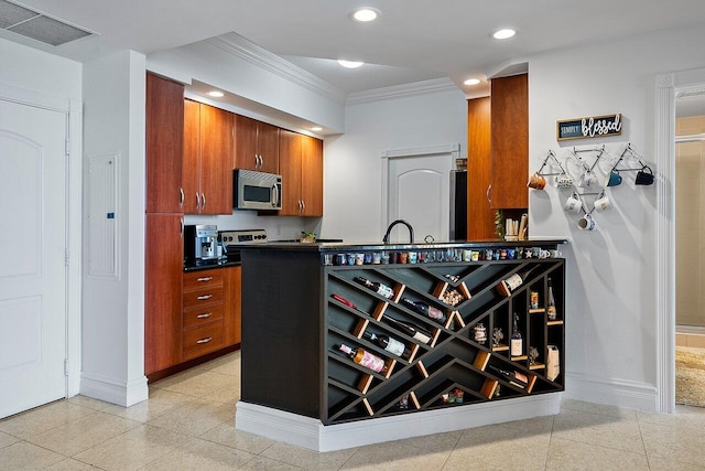 kitchen featuring sink, crown molding, and light tile floors