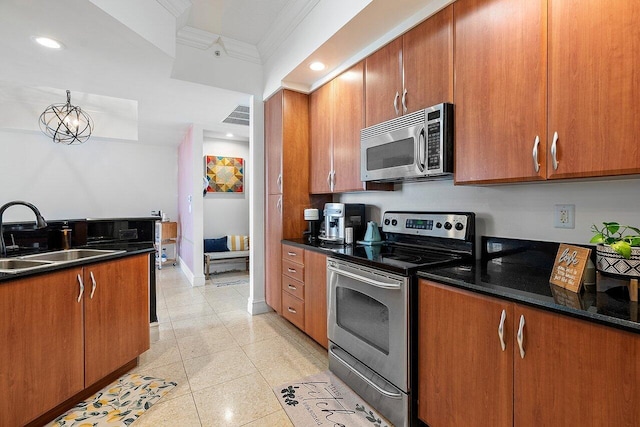 kitchen with crown molding, dark stone countertops, light tile floors, sink, and appliances with stainless steel finishes