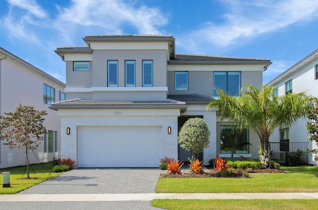 view of front facade with a garage and a front lawn