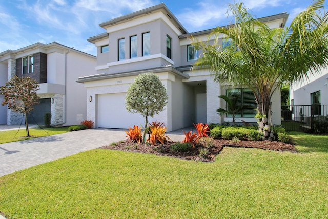 view of front facade featuring a garage and a front lawn