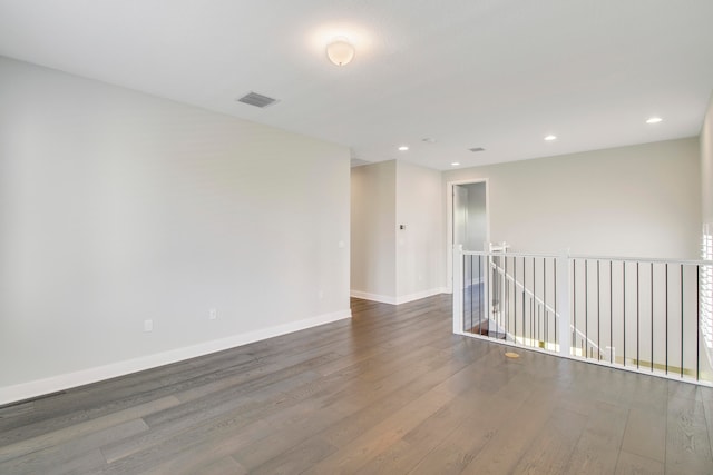 spare room featuring dark wood-type flooring