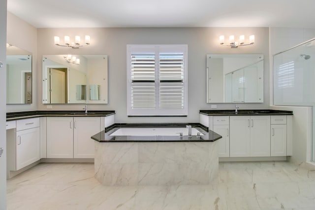 bathroom with oversized vanity, dual sinks, tile floors, and tiled tub