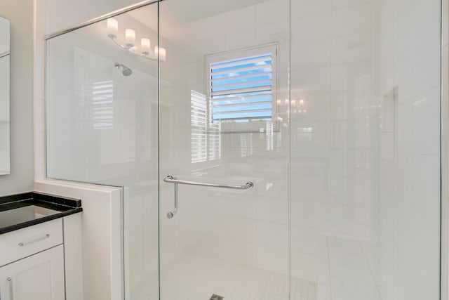 bathroom with a shower with door and vanity