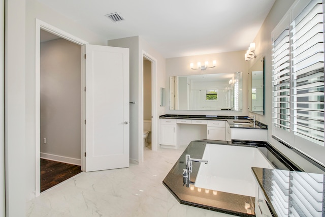 bathroom featuring tile floors, vanity, toilet, and a chandelier