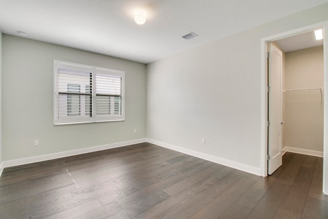 spare room featuring dark hardwood / wood-style flooring