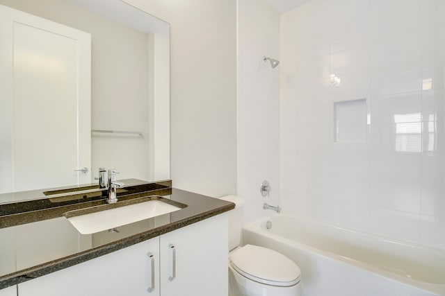 full bathroom featuring toilet, vanity, and tiled shower / bath