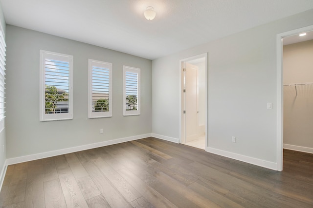 empty room with dark hardwood / wood-style floors