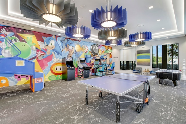 game room featuring billiards and a tray ceiling