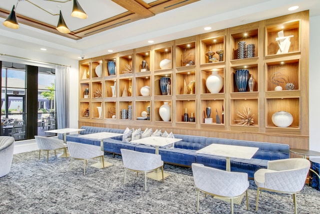 interior space featuring coffered ceiling and built in shelves