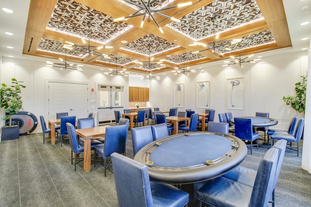 carpeted dining space with a chandelier and coffered ceiling