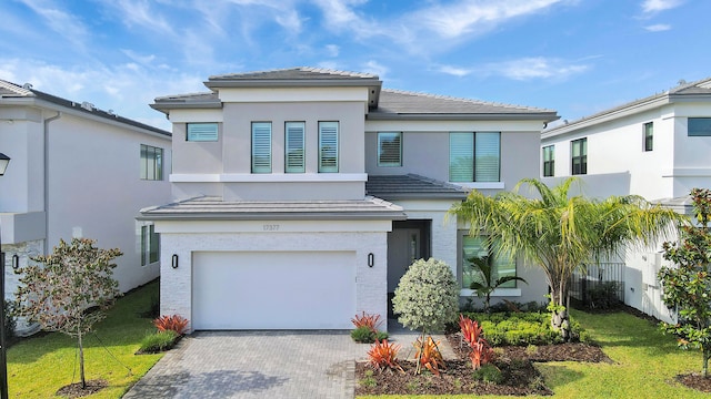 view of front of house with a front yard and a garage