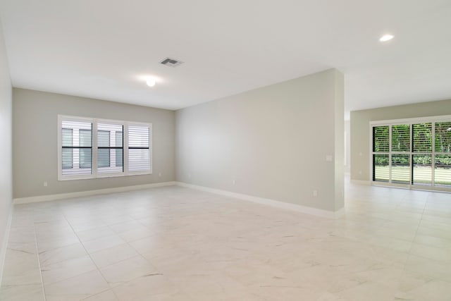 unfurnished room with light tile flooring