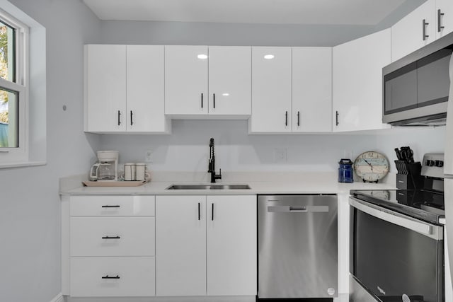 kitchen featuring white cabinets, sink, and stainless steel appliances